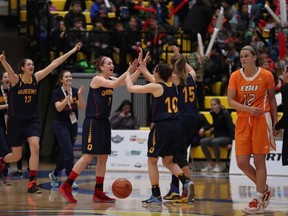 Queen's Gaels players celebrate their 60-51 win over the Cape Breton Capers in a quarter-final game at the U Sports national women's basketball championship tournament in Victoria on Thursday. (Chad Hipolito/The Canadian Press)