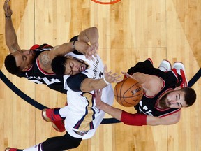 New Orleans Pelicans forward Anthony Davis is fouled as he goes to the basket against Toronto Raptors guard Norman Powell and centre Jonas Valanciunas during an NBA game on March 8, 2017. (AP Photo/Gerald Herbert)