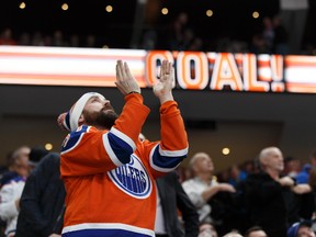 A fan applauds Edmonton's Matt Hendricks (23) goal during the second period of a NHL game at Rogers Place in Edmonton on Friday, January 20, 2017.