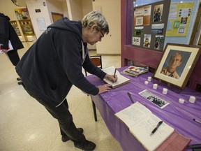 Janice Patterson, an English teacher, signs a book of condolences for Bruce McCallum on Thursday March 9, 2017. Bruce McCallum, a teacher at Albert Campbell Collegiate Institute in Scarborough, was killed in Costa Rica. (Craig Robertson/Toronto Sun)
