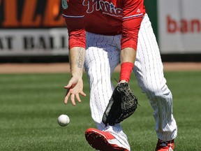 Philadelphia Phillies right fielder Michael Saunders reaches down to field a bloop single by Minnesota Twins' Eddie Rosario during a spring training game on March 3, 2017. (AP Photo/Chris O'Meara)