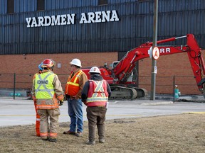 Union Gas workers confer with Acting Captain Pete Huffman of the Belleville Fire Department at the scene of a gas line leak outside Yardmen Arena Friday morning. City facilities manager Peter Lyng said contractors struck the low-pressure line at about 8 a.m.