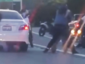 Witness video of a gang of bikers appearing to attack a motorist in California.