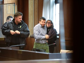 Defense attorney Cristina Bergner, right, and her client Evgeny Pavlov, a Bombardier employee, second right, pictured prior to the pre-trial at the Stockholm District Court, Sweden, Friday, March 10, 2017. A Russian employee in the Swedish offices of plane and train maker Bombardier has been detained in pre-trial custody for two weeks on suspicion of aggravated bribery, a Swedish prosecutor said Friday. (Soren Andersson / TT via AP)