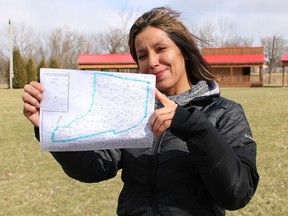 Marina Plain, of the Aamjiwnaang Heritage & Culture Club, is pictured Friday with a map showing the route of the upcoming Anishnaabeg Run, Walk, Paddle & Ride Relay. The 600-kilometre trek planned for mid-July will take visitors through seven First Nations communities in Southwestern Ontario. (Barbara Simpson/Sarnia Observer)