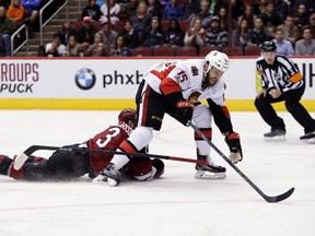 Ottawa Senators centre Zack Smith tries to get away from Arizona Coyotes defenceman Oliver Ekman-Larsson during an NHL game on March 9, 2017. (AP Photo/Rick Scuteri)