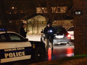 In this March 3, 2017, photo, detectives and officers work the scene after a deadly shooting in Bowling Green, Ky. Police in Kentucky have arrested a man who they say walked into the office of his wife's naturopathic caregiver and shot him dead. Omer Ahmetovic of Bowling Green has pleaded not guilty to a murder charge and was being held in the local jail Friday, March 10. (Joe Imel/Daily News via AP)
