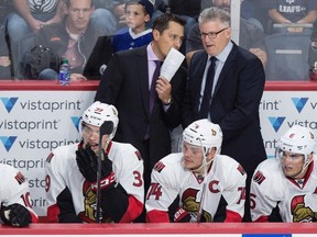 Ottawa Senators head coach Guy Boucher speaks with associate coach Marc Crawford during an NHL game against the Toronto Maple Leafs in Halifax on Sept. 26, 2016. (THE CANADIAN PRESS/Darren Calabrese)