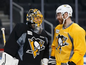 Pittsburgh Penguins goaltender Marc-Andre Fleury chats with defenceman Ian Cole during a practice at Rogers Place in Edmonton ahead of Friday's game against the Oilers. (Ian Kucerak)