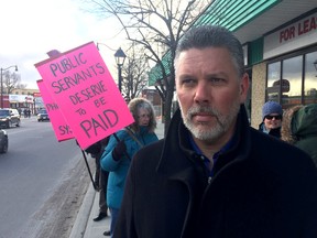 Jason Godin, president of the Union of Canadian Correctional Officers, during a picket about the Phoenix pay system with about a dozen federal employees in front of Kingston and the Island MP Mark Gerretsen's constituency office on Friday.  (Ian MacAlpine /The Whig-Standard)