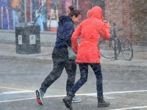 Pedestrians cross at Talbot and King streets in blowing snow as the London area continued its seesaw ride of winter weather Friday. The city has seen record warmth in February, wicked winds that wracked the region this week, to a snowsquall warning Friday ? and next week?s March break is looking chilly, too. (MORRIS LAMONT, The London Free Press)