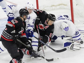 Toronto Maple Leafs goalie Curtis McElhinney tries to cover the puck during an NHL game against the Carolina Hurricanes on Feb. 19, 2017. (AP Photo/Gerry Broome)