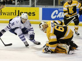 Kingston Frontenacs' Jeremy Helvig freezes the puck in front of Mississauga Steelheads' Ryan McLeod during Ontario Hockey League action at the Rogers K-Rock Centre on Friday. (Ian MacAlpine/The Whig-Standard)