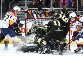 Referee Scott Ferguson waves off a goal as the entire Knights squad convene in the Knights crease with Tyler Parsons to keep the puck out, keeping Taylor Raddysh and Alex DeBrincat at bay during their game at Budweiser Gardens on Friday March 10, 2017. From left is Olli Juolevi, Janne Kuokkanen, Parsons, Owen MacDonald, Mitchell Vande Sompel and Mitchell Stephens. (MIKE HENSEN, The London Free Press)