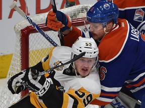 Edmonton Oilers defenceman Adam Larsson and Pittsburgh Penguins' Jake Guentzel jockey for position in front of the net at Rogers Place in Edmonton on Saturday, March 10, 2017. (Ed Kaiser)