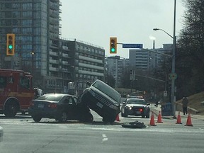 A car topples on another after a crash in North York Saturday morning. (TWITTER)