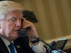 U.S. President Donald Trump speaks on the phone with Russian President Vladimir Putin in the Oval Office of the White House, Jan. 28, 2017 in Washington, D.C.  (Photo by Drew Angerer/Getty Images)