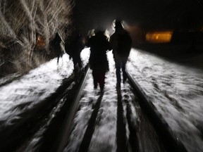 Early Sunday morning, February 26, 2017, eight migrants from Somalia cross into Canada illegally from the United States by walking down this train track into the town of Emerson, Man., where they will seek asylum at Canada Border Services Agency. (THE CANADIAN PRESS/John Woods).