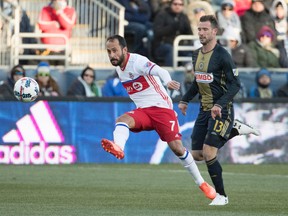 Toronto FC's Victor Vazquez kicks the ball up the field with Philadelphia Union's Chris Pontius trailing during Saturday's game. (AP)