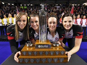Skip Rachel Homan, left to right, third Emma Miskew, second Joanne Courtney and lead Lisa Weagle pose with the trophy at the Scotties Tournament of Hearts in St. Catharines, Ont., on Sunday, Feb. 26, 2017. (THE CANADIAN PRESS/Sean Kilpatrick)
