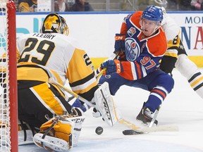 Pittsburgh Penguins goalie Marc-Andre Fleury (29) makes the save on Edmonton Oilers' Connor McDavid (97) during second period NHL action in Edmonton, Alta., on Friday, March 10, 2017.