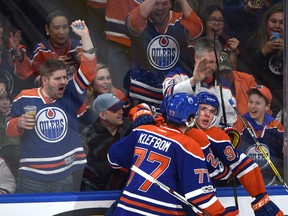 Edmonton Oilers Connor McDavid (97) celebrates scoring the tying goal with Leon Draisaitl (29) and Oscar Klefbom (77) against the Pittsburgh Penguins during third period NHL action at Rogers Place in Edmonton, Saturday, March 10, 2017.