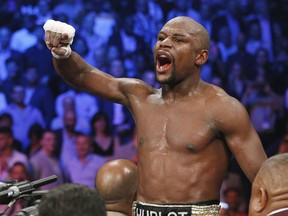 In this May 2, 2015, file photo, boxer Floyd Mayweather Jr., celebrates his victory over Manny Pacquiao in Las Vegas. (AP Photo/John Locher, File)