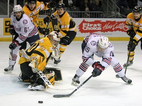 Oshawa Generals Kyle MacLean tries to wrap the puck around Kingston Frontenacs Jeremy Helvig during the first period of Ontario Hockey League action at the Rogers K-Rock Centre in Kingston, Ont. on Saturday March 11, 2017. The Generals defeated the Fronts 3-2. Steph Crosier/Kingston Whig-Standard/Postmedia Network