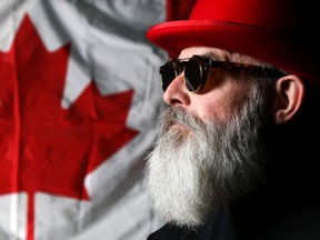 Andy Forgie poses in front of a Canadian flag backstage at The Empire Theatre in Belleville. Forgie discusses the song he wrote 25 years ago, This is Canada, for Canada's 125th anniversary. Tim Miller/The Intelligencer