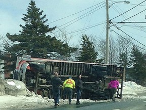 People look on as a truck lies on its side in Paradise, N.L., on Saturday, March 11, 2017 in this handout photo.  THE CANADIAN PRESS/HO, Troy Mitchell