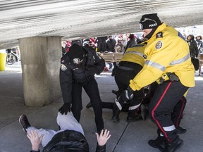 Toronto Police  break up a fight earlier this month at a City hall protest. (CRAIG ROBERTSON, Toronto Sun)