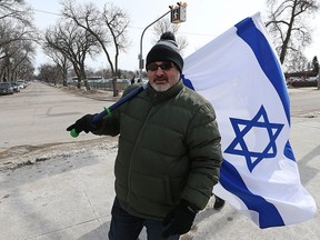 Organizer Ron East walks with an Israeli flag during a rally outside the Rady Jewish Community Centre on Sun., March 12, 2017. The centre was briefly evacuated Thursday after to a threat to the building. Kevin King/Winnipeg Sun/Postmedia Network