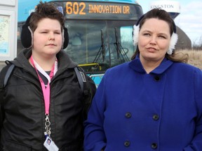 Rachael Forsyth with her son Evan at the bus stop that Evan will use to get to La Salle Secondary School. (Steph Crosier/The Whig-Standard)