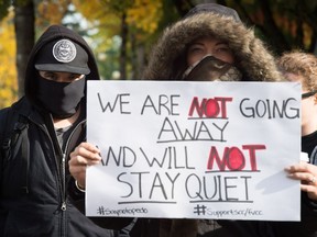 Members of the vigilante group Surrey Creep Catchers stand outside B.C. Provincial Court before a scheduled appearance for RCMP Const. Dario Devic, who was charged with luring a child after the group alleged a man was trying to solicit an underage girl for sex, in Surrey, B.C., on Wednesday October 19, 2016. (THE CANADIAN PRESS/Darryl Dyck)