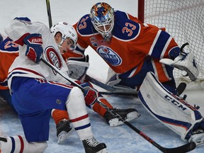 Edmonton Oilers goalie Cam Talbot eyes the puck as Montreal Canadiens Artturi Lehkonen loses his footing at Rogers Place in Edmonton on Sunday, March 12, 2017. (Ed Kaiser)