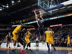 Carleton Ravens’ Mitch Wood (centre) scores against the Ryerson Rams during the USports basketball national championship game in Halifax yesterday. (THE CANADIAN PRESS)