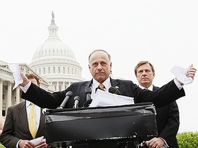 U.S. Rep. Steve King (R-IA) tears a page from the national health care bill during a press conference at the U.S. Capitol March 21, 2012 in Washington, DC.