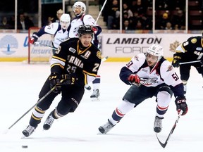 Sarnia Sting's Jordan Kyrou (25) is chased by Windsor Spitfires' Jalen Chatfield (51) in the first period at Progressive Auto Sales Arena on Friday, March 10, 2017. (MARK MALONE/The Daily News)