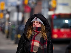 Martine Laplante was well bundled up Sunday March 12, 2017 as she braved the cold weather and made her way down along Dalhousie Street.