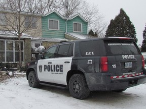 A Sarnia police vehicle is parked outside an address on Lanark Court Monday in Sarnia, Ont. A 21-year-old man who was allegedly stabbed on the street Sunday evening was being treated Monday in a London hospital. (Paul Morden/Sarnia Observer/Postmedia Network)