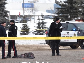 A long gun lies beside its case in the intersection of 50 St. And 137 Ave in north Edmonton on March 13, 2017.