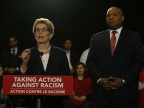 Ontario Premier Kathleen Wynne and Michael Coteau, the minister responsible for the province's anti-racism strategy.