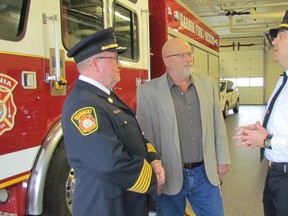 From left, Sarnia Fire Chief John Kingyens, Union Gas manager Greg Warner and fire safety educator Mike Otis, speak Monday at the fire hall on East Street in Sarnia about an inflatable fire safety house to be purchased for the Sarnia Fire Rescue Service. Union Gas made a $1,000 donation to the project. (Paul Morden/Sarnia Observer)