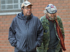 Controversial group home owner Keith Charles stands with Donald Stewart, a resident in one of his homes, outside Provincial Offences Court in London Monday. (MORRIS LAMONT, The London Free Press)