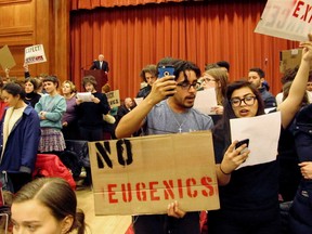 Middlebury College students turn their backs to Charles Murray, who they call a white nationalist, during his lecture in Middlebury, Vt., on Thursday, March 2, 2017. Hundreds of college students protested the lecture, forcing the college to move his talk to an undisclosed campus location from which it was live-streamed to the original venue but couldn't be heard above protesters' chants, feet stamping and occasional smoke alarms. (AP Photo/Lisa Rathke)