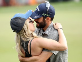 Adam Hadwin of Canada celebrates with fiancee Jessica Dawn on the 18th green after winning the Valspar Championship during the final round at Innisbrook Resort Copperhead Course on March 12, 2017. (Mike Lawrie/Getty Images)