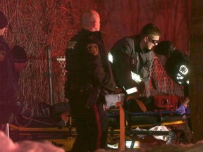 Police and paramedics tend to a 21-year-old woman who sustained life-threatening injuries and appeared to have been shot outside a residence in the 200-block of Spence Street in Winnipeg on Sunday, March 12, 2017 at around 10 p.m. She was taken to hospital where she was pronounced dead. On Monday, Winnipeg Police were asking for information in the shooting death. CHRIS PROCAYLO/Winnipeg Sun
