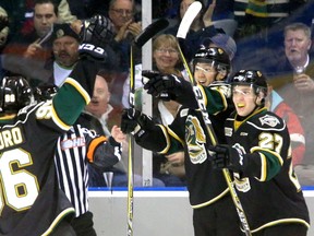 Cliff Pu of the Knights celebrates his first period goal against the Erie Otters with teammates Dante Salituro and Robert Thomas during their game at Budweiser Gardens on Friday March 10, 2017. (MIKE HENSEN, The London Free Press)