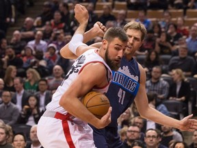 Toronto Raptors centre Jonas Valanciunas looks for space as he tries to get away from Dallas Mavericks forward Dirk Nowitzki during an NBA game on March 13, 2017. (THE CANADIAN PRESS/Chris Young)