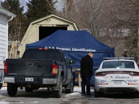 Members of the Greater Sudbury Police forensic unit, the Coroner and the Office of the Ontario Fire Marshal continue to process the scene and collect evidence at a homicide investigation on Bancroft Drive in Sudbury, Ont. on Monday March 13, 2017. John Lappa/Sudbury Star/Postmedia Network